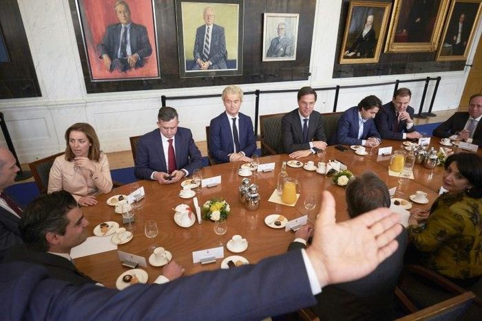 Dutch Prime Minister Mark Rutte (background 4thR) and Dutch PVV leader Geert Wilders (C) pose with other party leaders before a meeting with Chairman of the Senate Khadija Arib (4thL) in The Hague, on March 16, 2017, a day after general elections