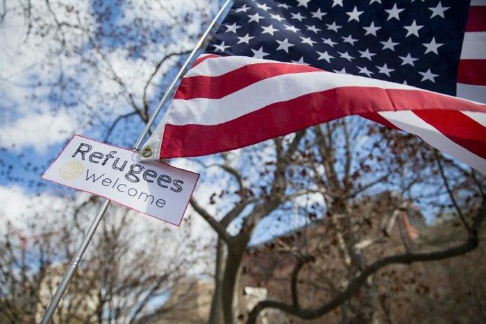 A protester holds a sign near the White House to protest President Donald Trump's travel ban on six Muslim countries on March 11, 2017