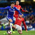 Chelsea midfielder Eden Hazard (L) is tackled by Manchester United defender Marcos Rojo during the FA Cup quarter-final at Stamford Bridge in west London on March 13, 2017
