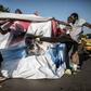 A supporter of the newly elected Gambia President Adama Barrow kicks a poster of the exiting leader Yahya Jammeh in Serekunda