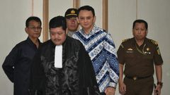 Jakarta's Christian governor Basuki Tjahaja Purnama (2nd R), popularly known as Ahok, arrives at a courtroom for a verdict and sentence in his blasphemy trial