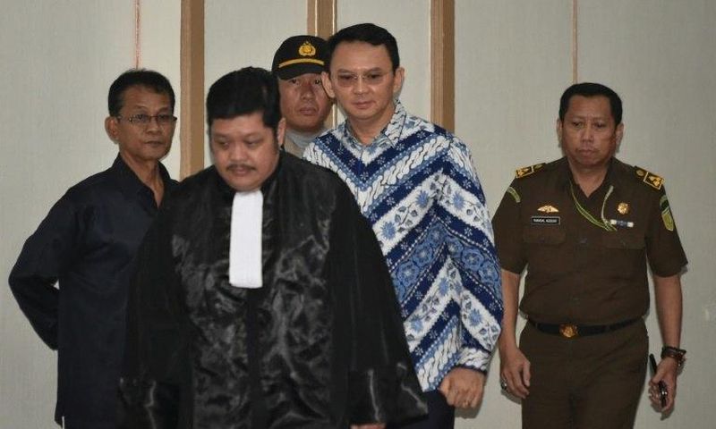 Jakarta's Christian governor Basuki Tjahaja Purnama (2nd R), popularly known as Ahok, arrives at a courtroom for a verdict and sentence in his blasphemy trial