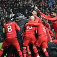 Lyon's players celebrate their victory at the end of the UEFA Europa League second leg quarter final football match against Besiktas April 20, 2017