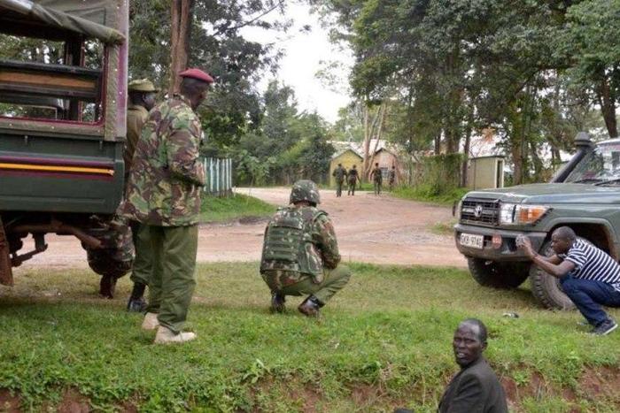 Kenyan police officers hold their position during the deadly shooting at the Kapenguria police station.