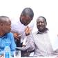 The late Raila Odinga speaking with Edwin Sifuna. John Mbadi looks on
