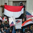People rally with flags at Brooklyn Borough Hall as Yemeni bodega and grocery-stores shut down to protest US President Donald Trump's Executive Order banning immigrants and refugees from seven Muslim-majority countries on February 2, 2017 in New York