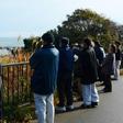 Local residents look out to sea from higher ground after evacuating their homes following a 6.9 magnitude earthquake and tsunami alert in Iwaki, Fukushima prefecture, on November 22, 2016