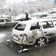 A policeman investigates a burned out car in the suburb Rinkeby, outside Stockholm, on February 21, 2017
