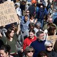 People hold placards during a pro-refugee demonstration in the Spanish Basque city of San Sebastian on February 26, 2017 as Spain has resettled only 1,100 of the 16,200 refugees it pledged to take in within two years