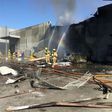 Firemen put out a blaze from a light aircraft which exploded as it smashed into a shopping centre near Melbourne on February 21, 2017 killing five people aboard