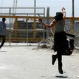 Palestinian protesters hurl stones towards Israeli security forces during clashes following a demonstration in solidarity with hunger-striking Palestinian prisoners, in front of Ofer prison in the West Bank, on April 20, 2017