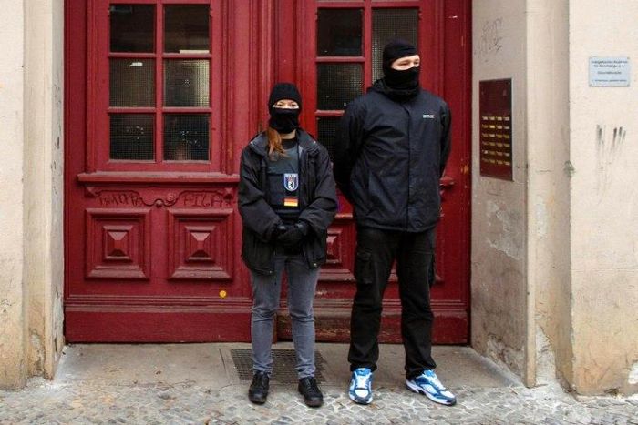 Police officers stand in front of the "Fussilet 33" mosque in Berlin, raided on Tuesday