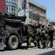 Afghan security forces take up a position at the site of suicide bombing in Jalalabad on May 17, 2017