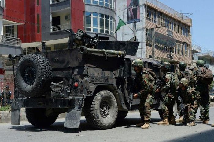 Afghan security forces take up a position at the site of suicide bombing in Jalalabad on May 17, 2017