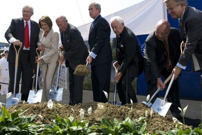 Top US diplomat and China scholar Richard Solomon, pictured (L) at a ground breaking ceremony with president George W. Bush (C)in 2008, has died aged 79