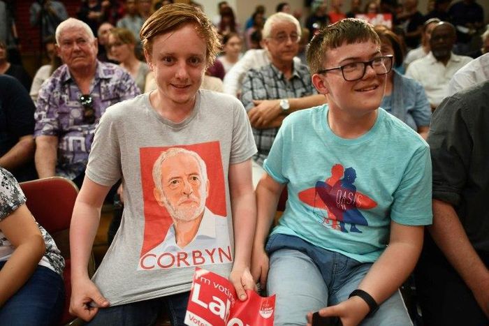 A young Labour Party supporter shows off his T-shirt with the face of Jeremy Corbyn at an election rally in Basildon