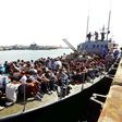 Migrants whose boat was intercepted by the Libyan coastguard in the Mediterranean arrive at a naval base in the capital Tripoli on May 10, 2017