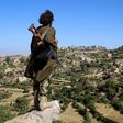 A Yemeni tribesman from the Popular Resistance Committee, supporting forces loyal to Saudi-backed President Abedrabbo Mansour Hadi, stands on a hill in the central city of Taiz, on November 1, 2016