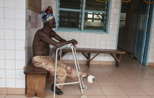 A man who lost his left foot to leprosy, waits for treatment at the Raoul Follereau Foundation facility in Pobe, Benin