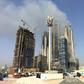 Smoke billows near the Dubai Mall and Burj Khalifa, the world's tallest building, after a fire hit the construction site in Dubai on April 2, 2017