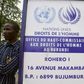 A man stands by a sign outside the UN Commission on Human Rights headquarters in Burundi as people demonstrate against the EE, the ICC and the Resolution against Burundi in Bujumbura on October 8, 2016