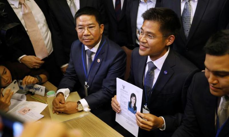 A party official holds a registration document bearing the image of Thai Princess Ubolratana, who will run for PM