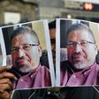 A photojournalist shows pictures of Mexican journalist Javier Valdez, murdered a day earlier, during a protest in Mexico City on May 16, 2017