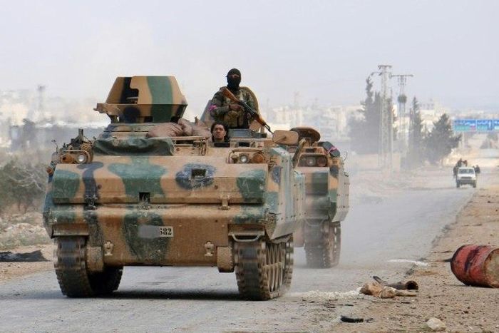 Turkey-backed opposition fighters advance in an armoured personnel carrier outside the northern Syrian city of al-Bab during a drive to retake control from the Islamic State group on February 9, 2017