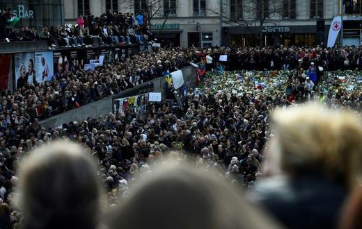 People attend a memorial ceremony on April 9, 2017 at Sergels Torg plaza in Stockholm, Sweden, close to the point where a truck drove into a department store two days before
