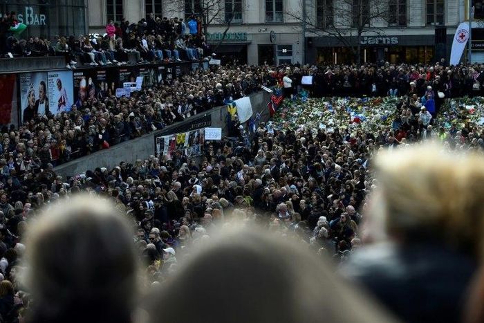People attend a memorial ceremony on April 9, 2017 at Sergels Torg plaza in Stockholm, Sweden, close to the point where a truck drove into a department store two days before