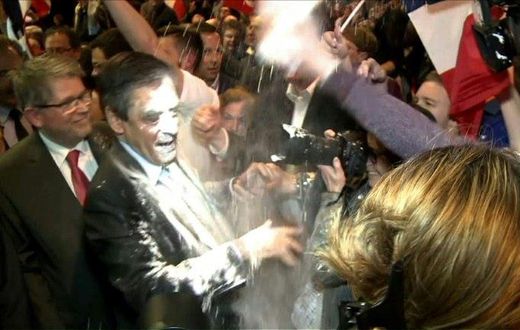 French presidential election candidate for the right-wing Les Republicains (LR) party Francois Fillon (C) reacting as a man throw flour at him on April 6, 2017 during a political rally in Strasbourg, northeastern France