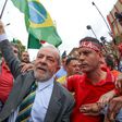 Brazil's former president Luiz Inacio Lula da Silva walks amid supporters as he arrives at a Federal Justice Court in Curitiba on May 10, 2017