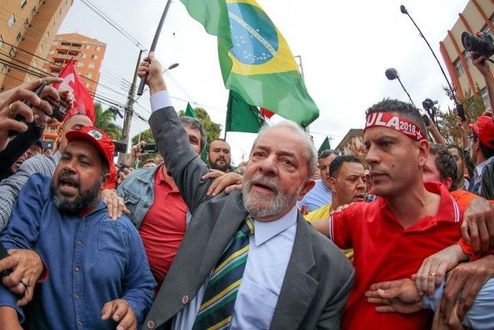Brazil's former president Luiz Inacio Lula da Silva walks amid supporters as he arrives at a Federal Justice Court in Curitiba on May 10, 2017