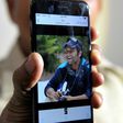 Jagan Mohan Reddy holds a smartphone with an image of his son Alok Madasani at his residence in Hyderabad on February 24, 2017, after Alok was injured in the shooting of two Indian men in the US state of Kansas