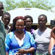Sharon Otieno's father Douglas Otieno (left) and mother Melida Auma (centre) joined by their relatives