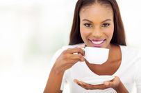 Beautiful woman drinking tea at home