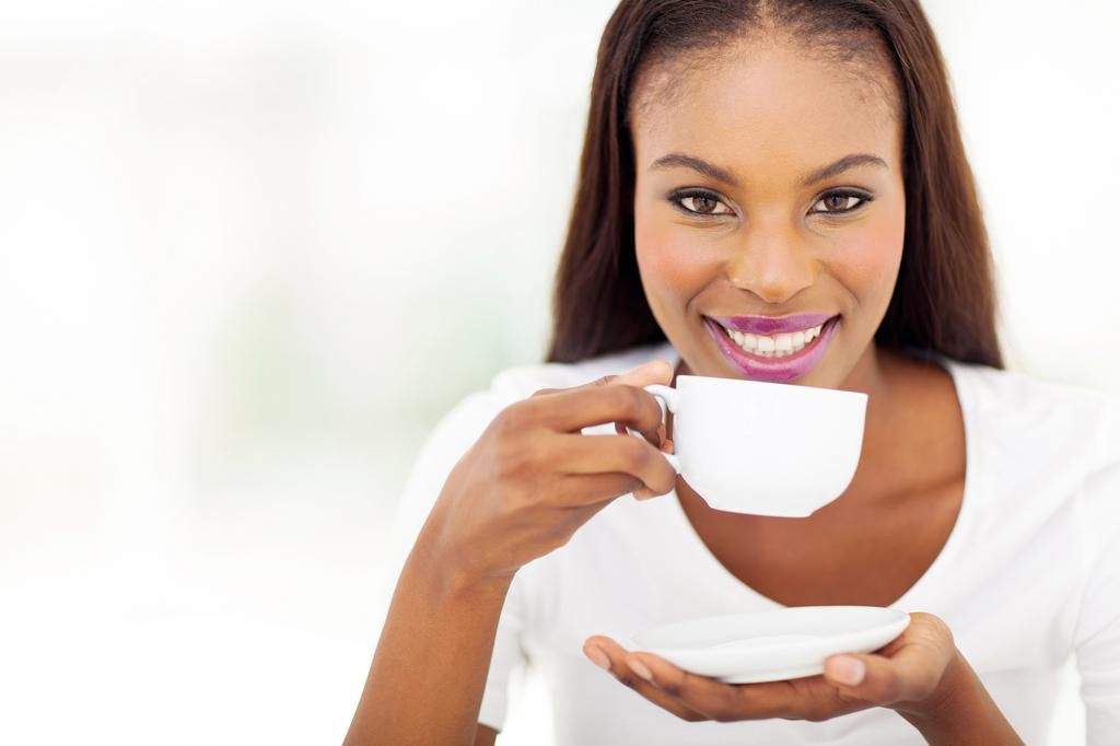 Beautiful woman drinking tea at home