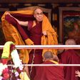 Exiled Tibetan spiritual leader the Dalai Lama adjusts his shawl as he arrives to deliver teachings to Buddhist followers at the Yiga Choezin ground in Tawang near the India-China border