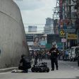 Bomb squad operatives and a bomb disposal robot inspect a suspicious package in Quiapo, Manila on May 7, 2017