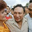 Panamanian dictator Manuel Antonio Noriega hugs supporters on a visit to a remote town in June 1987