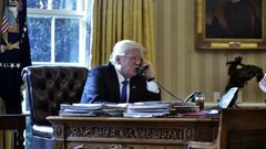 US President Donald Trump speaks on the phone with Russia's President Vladimir Putin from the Oval Office of the White House on January 28, 2017
