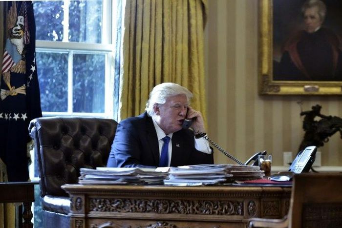 US President Donald Trump speaks on the phone with Russia's President Vladimir Putin from the Oval Office of the White House on January 28, 2017
