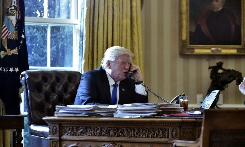 US President Donald Trump speaks on the phone with Russia's President Vladimir Putin from the Oval Office of the White House on January 28, 2017