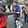 An activist (left) favouring unification with China clashes with pro-unification activists on the 70th anniversary of the 228 incident at the Chiang Kai-shek Memorial Hall in Taipei on February 28, 2017