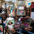 Ethiopian Israelis hold up photographs of relatives in a protest outside the premier's office in Jerusalem on March 20, 2016