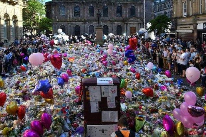 Flowers, toys and balloons cover St Ann's Square in central Manchester to honour the 22 people killed at the concert attack