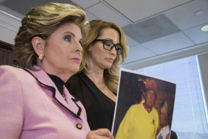 Attorney Gloria Allred holds a photo of Jessica Drake (R) with Donald Trump, taken in 2006 during an event where Drake alleges Trump behaved in an sexually inappropriate way toward her