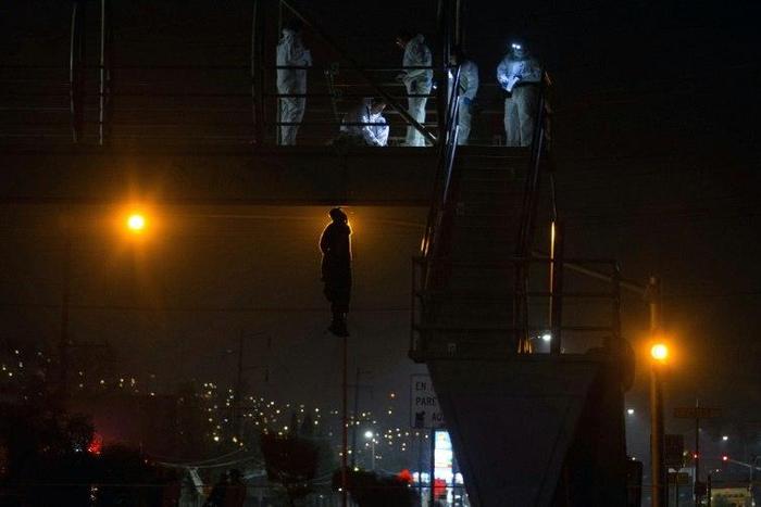 The body of a man hangs from a bridge in Tijuana, northwestern Mexico, on late Nov 2, 2016