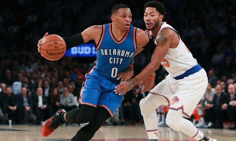 Oklahoma City Thunder's Russell Westbrook drives to the basket defended by the New York Knicks's Derrick Rose as he notches up five straight triple-doubles