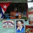 A farmer decorates his stall as he waits for the urn with the ashes of Cuban leader Fidel Castro to be driven through the streets of Las Tunas